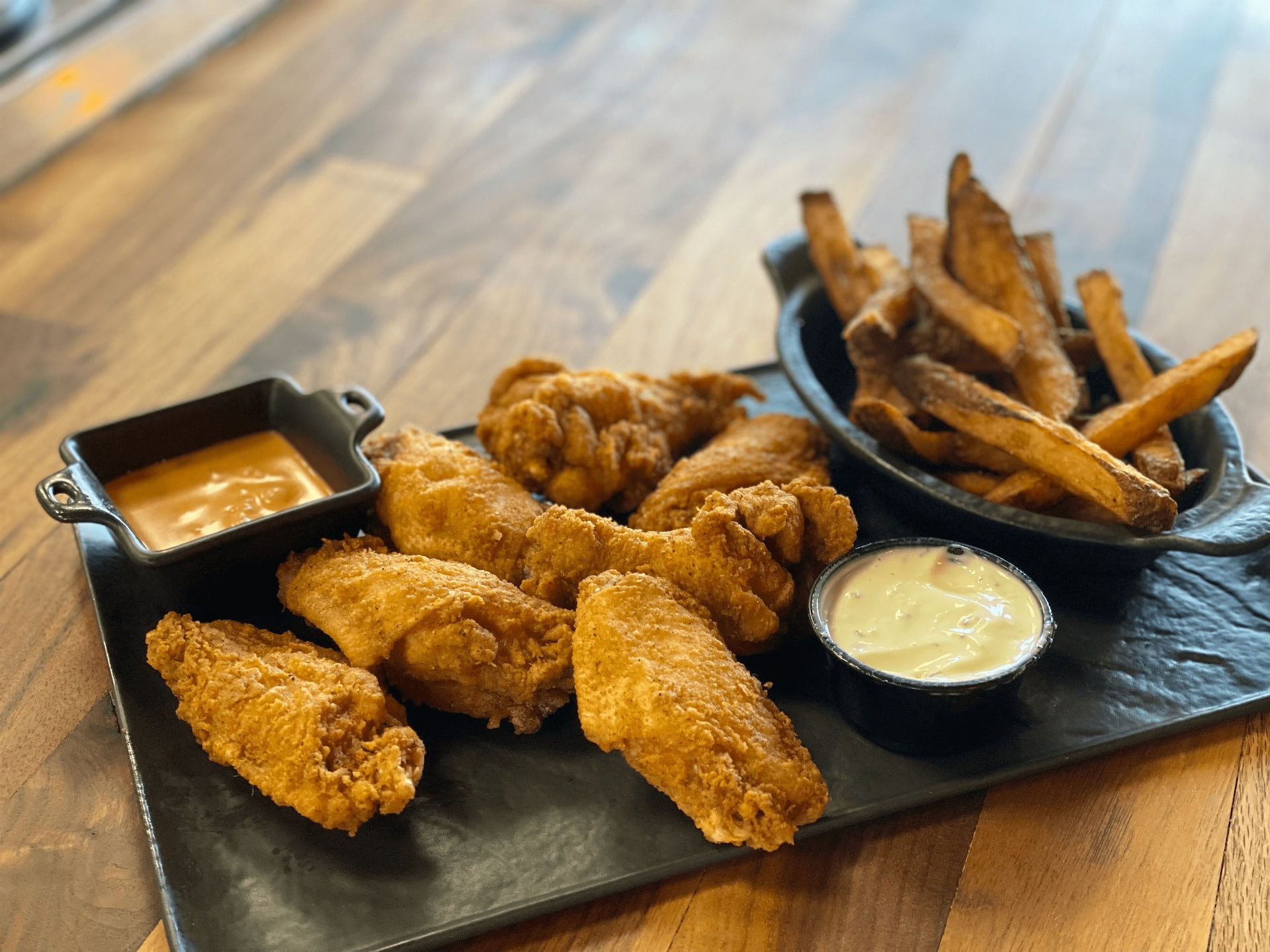 Chicken wings and fries with dipping sauces